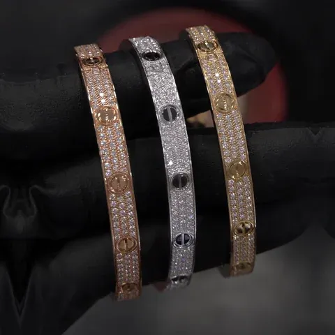 Three Cartier Love bracelets in rose, white and yellow gold