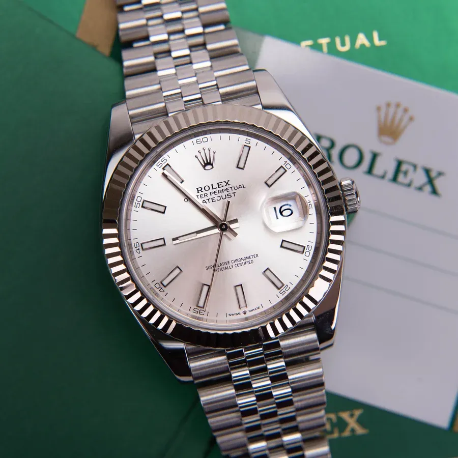 A steel Rolex Datejust 41 with a silver dial, fluted bezel and Jubilee bracelet, with a Rolex warranty card