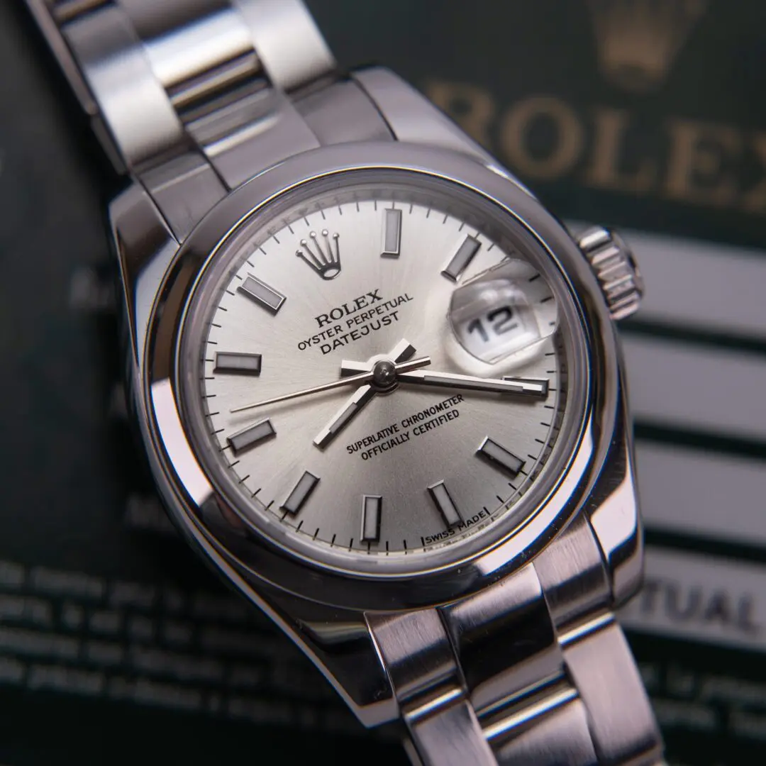 Silver Rolex watch with date display.