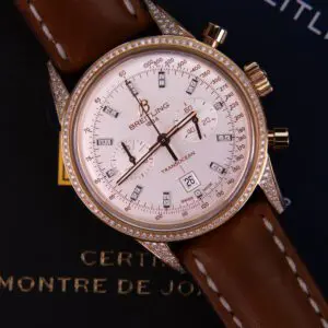 Luxury watch with diamond bezel and leather strap.