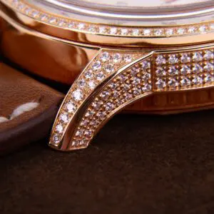 Luxury watch with diamond-encrusted bezel detail.