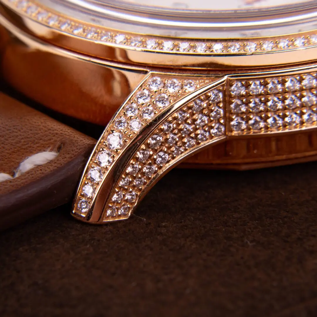 Luxury watch with diamond-encrusted bezel detail.