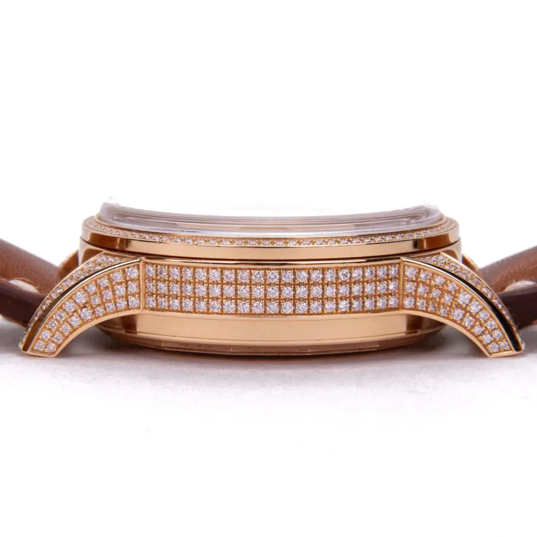 Gold watch with diamond accents and strap.