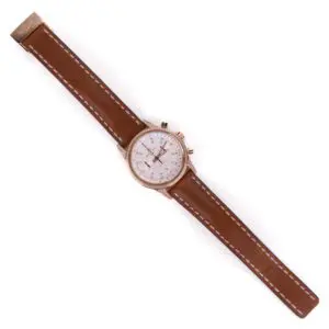 Brown leather strap watch with white dial.