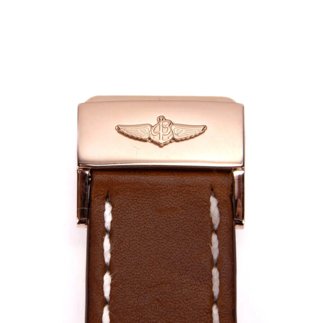 Brown leather watch strap with metal clasp.