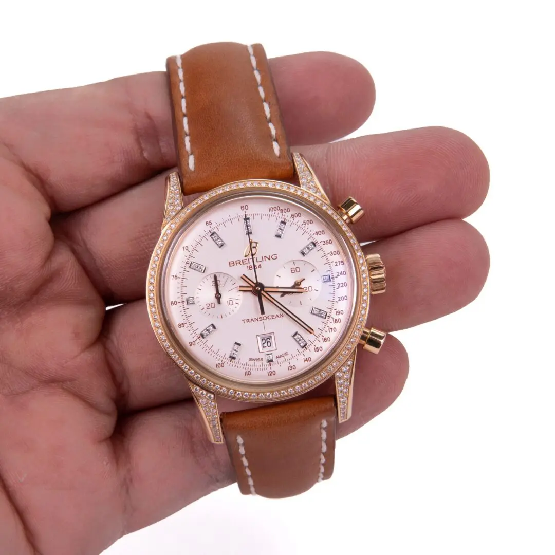 Brown leather watch in a hand.