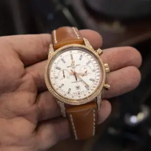 Luxury watch with brown leather strap.