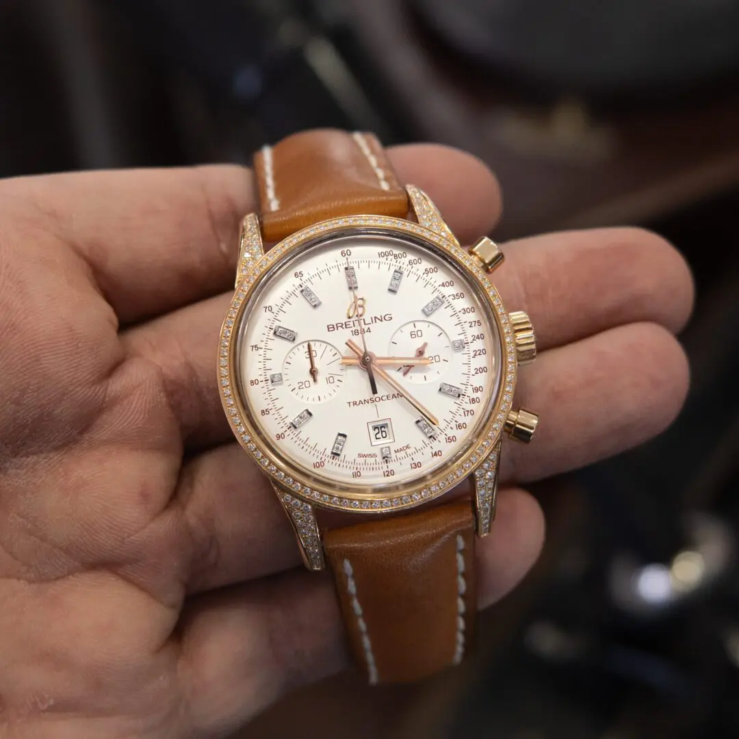 Luxury watch with brown leather strap.