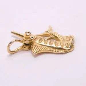 Gold fish-shaped keychain on white background.