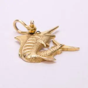 Gold swordfish-shaped pendant on white background.