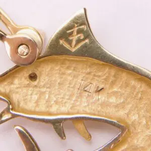 Gold fish-shaped brooch with 14K marking.