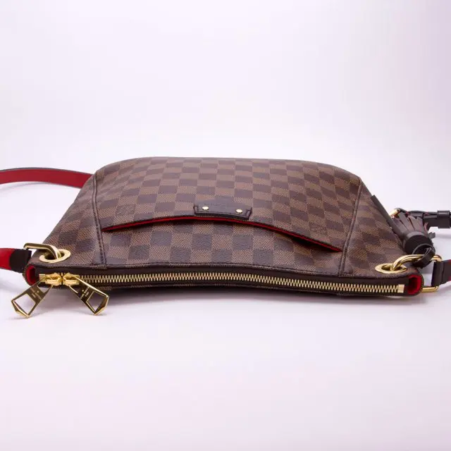 Brown checkered handbag with gold accents.