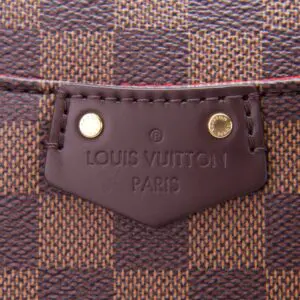 Louis Vuitton bag close-up, brown checkered pattern.