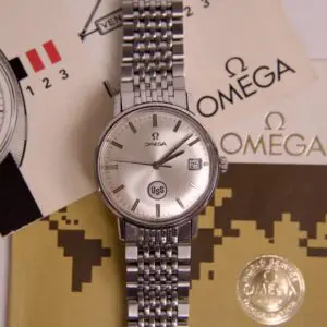 Omega watch with documents and packaging.