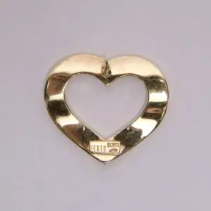 Gold heart-shaped metal object on display.