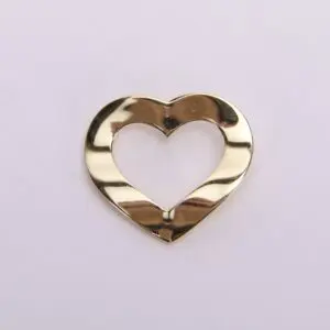 Gold heart-shaped metallic cutout on white.