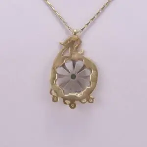 Gold necklace with floral pendant design.