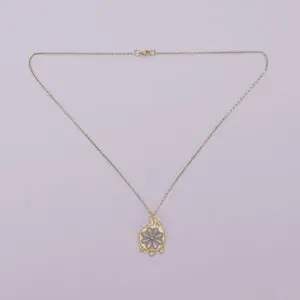 Gold necklace with decorative pendant.