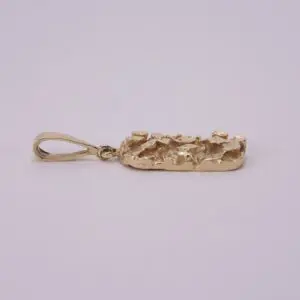 Gold nugget pendant on a plain background.