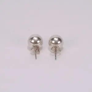Silver stud earrings on white background.