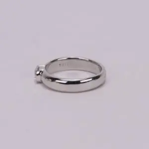 Silver engagement ring with small diamond.