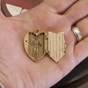 Heart-shaped locket with hidden skeleton inside.