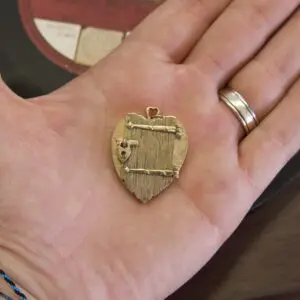 Heart-shaped locket in a person's hand.