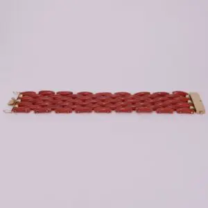 Red link bracelet on light background.
