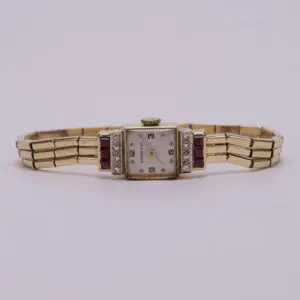 Gold vintage wristwatch with ruby accents.
