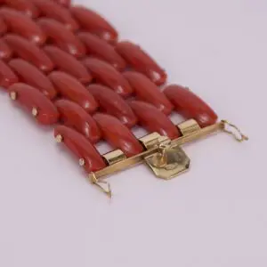 Red coral bracelet with gold clasp.