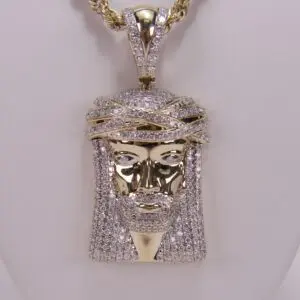 Gold diamond Jesus pendant necklace on display.