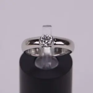 Silver ring with a central diamond.