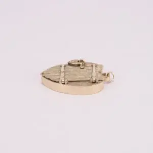 Gold shield-shaped pendant on white background.