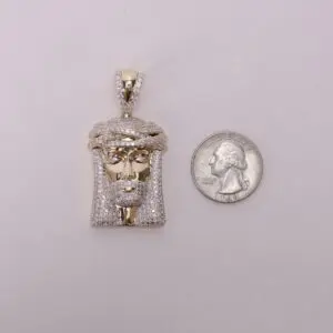 Gold pendant and quarter for size comparison.
