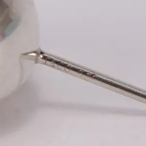 Close-up of engraved metal rod detail.