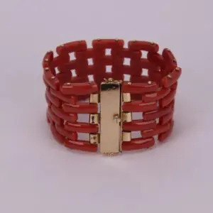 Red bracelet with gold clasp details.