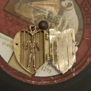 Heart-shaped locket on vintage record.