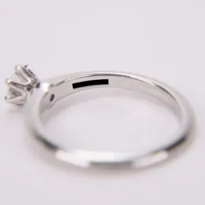Silver ring with diamond and engraved details.