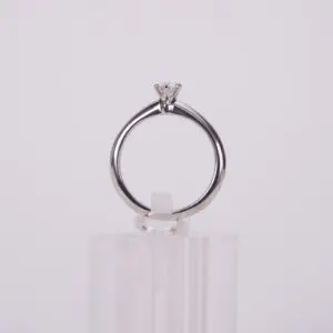 Diamond ring on clear stand.