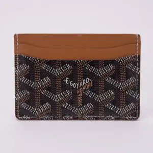 Patterned card holder with brown leather trim.