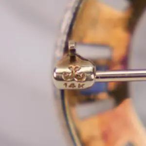Close-up of a 14k gold earring.