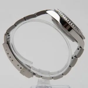 Luxury watch with metal bracelet, side view.