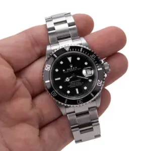 Hand holding a luxury wristwatch.