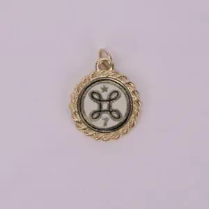 Gold pendant with intricate circular design.