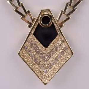 Gold pendant with geometric design and gemstones.