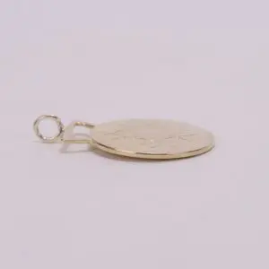 Gold pendant with engraved leaf design.