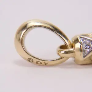 Gold jewelry loop with diamond detail.