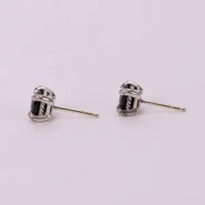Silver earrings with black gemstone accents.