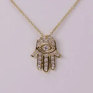 Gold Hamsa pendant with diamond accents.