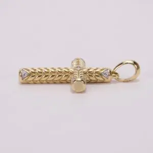 Gold cross pendant with intricate braid design.